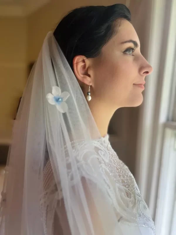 Bella Earrings with silver plating being modeled on a bride